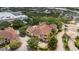 Overhead view of a community apartment building, landscaping, parking, and a shopping center nearby at 12414 Baleria Cv # 104, Orlando, FL 32837