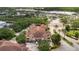 Aerial view of a community apartment building, parking, and shopping center in the background at 12414 Baleria Cv # 104, Orlando, FL 32837
