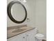 Bathroom featuring a toilet and a vanity with a sink and a large mirror at 12414 Baleria Cv # 104, Orlando, FL 32837