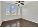 Bedroom with hardwood floors, ceiling fan, and three windows at 12414 Baleria Cv # 104, Orlando, FL 32837