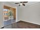 Bedroom with dark wood floors and glass doors leading to a balcony at 12414 Baleria Cv # 104, Orlando, FL 32837