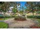 A charming courtyard with a circular brick area, seating, and lush landscaping, creating a peaceful outdoor retreat at 12414 Baleria Cv # 104, Orlando, FL 32837