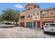 Exterior of a three-story townhome with individual garages and welcoming curb appeal at 12414 Baleria Cv # 104, Orlando, FL 32837