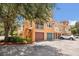 Three-story townhome with stairs leading to the second level and individual garages at 12414 Baleria Cv # 104, Orlando, FL 32837