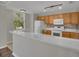 Bright kitchen featuring white countertops, stainless steel sink, and wooden cabinets at 12414 Baleria Cv # 104, Orlando, FL 32837