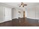 Inviting living room with hardwood floors, neutral paint, and arched doorway leading to kitchen at 12414 Baleria Cv # 104, Orlando, FL 32837