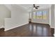 Spacious living room features hardwood floors, neutral paint, and large windows, showcasing natural light at 12414 Baleria Cv # 104, Orlando, FL 32837