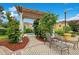 A serene pool area with a pergola, chaise lounges, and lush landscaping, creating a perfect oasis at 12414 Baleria Cv # 104, Orlando, FL 32837