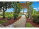 A beautifully landscaped walkway leading to a sparkling pool area, perfect for relaxation and recreation at 12414 Baleria Cv # 104, Orlando, FL 32837