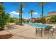 Community pool with tropical landscaping, and chairs for a relaxing experience at 12414 Baleria Cv # 104, Orlando, FL 32837