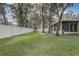 Well-maintained backyard with expansive lawn, playset, and privacy fence perfect for outdoor enjoyment at 1307 Pup Fish Ln, Deland, FL 32724