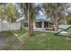 Backyard featuring a playset, large grassy area, a lanai, and fenced yard offering privacy and space at 1307 Pup Fish Ln, Deland, FL 32724