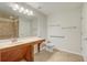 Well-lit bathroom featuring a single vanity, ceramic tile flooring, and accessibility handrails at 1307 Pup Fish Ln, Deland, FL 32724