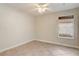 Cozy bedroom features neutral tile flooring, a window, and white trim and walls at 1307 Pup Fish Ln, Deland, FL 32724