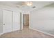 Neutral bedroom features a ceiling fan, closet, and white doors, trim, and walls at 1307 Pup Fish Ln, Deland, FL 32724