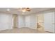 Bright bedroom with tile floors, a ceiling fan, and doors leading to bathrooms at 1307 Pup Fish Ln, Deland, FL 32724