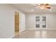 Bright bedroom offers a tile floor, ceiling fan, and French doors leading to the lanai at 1307 Pup Fish Ln, Deland, FL 32724