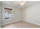 Bright bedroom features neutral tile floors, white trim and walls, and a window at 1307 Pup Fish Ln, Deland, FL 32724