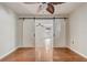 Bedroom featuring hardwood floors and sliding barn door access at 1307 Pup Fish Ln, Deland, FL 32724