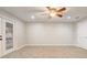 Neutral bedroom with tile floors, ceiling fan, and sliding glass door to the backyard at 1307 Pup Fish Ln, Deland, FL 32724