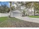 View of the home featuring an attached garage, landscaped yard, and classic design details at 1307 Pup Fish Ln, Deland, FL 32724