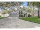 Charming one-story home with a well-manicured front yard and an attached two-car garage at 1307 Pup Fish Ln, Deland, FL 32724