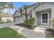 View of the home highlighting a two-car garage, landscaped entrance and covered front door at 1307 Pup Fish Ln, Deland, FL 32724