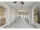 Screened lanai with ceiling fan, ample space, and multiple access points to the outdoors at 1307 Pup Fish Ln, Deland, FL 32724