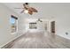 Bright living room featuring hardwood floors, multiple ceiling fans, and large windows at 1307 Pup Fish Ln, Deland, FL 32724