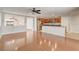 Open-concept living room featuring hardwood floors, a modern ceiling fan, and a view of the kitchen at 1307 Pup Fish Ln, Deland, FL 32724