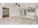 Open-concept living room showcasing light wood floors, neutral walls, and transitions to other rooms at 1307 Pup Fish Ln, Deland, FL 32724