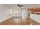 Open-concept living area with hardwood floors and a view into the kitchen with stainless appliances at 1307 Pup Fish Ln, Deland, FL 32724