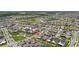 An aerial view of a community featuring single Gathering homes, green spaces and a lake in the distance at 13208 Leggett Aly, Orlando, FL 32827
