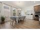 Bright dining area with large windows, chandelier lighting, and seating for six at 13208 Leggett Aly, Orlando, FL 32827