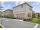 Two-story house showcasing a two-car garage, neutral siding, and manicured landscaping at 13208 Leggett Aly, Orlando, FL 32827