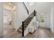 Bright foyer with a staircase, decorative bench and light wood-look tile flooring at 13208 Leggett Aly, Orlando, FL 32827