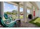 Inviting front porch featuring brick pavers, ample seating, and manicured lawn at 13208 Leggett Aly, Orlando, FL 32827