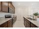 Modern kitchen features granite countertops, stainless steel appliances, and ample cabinet space at 13208 Leggett Aly, Orlando, FL 32827