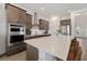 Modern kitchen with stainless steel appliances, a large center island, and sleek countertops at 13208 Leggett Aly, Orlando, FL 32827