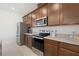 Well-appointed kitchen with stainless steel appliances, granite countertops, and ample storage at 13208 Leggett Aly, Orlando, FL 32827