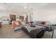 Open-concept living area with stylish furnishings, tile floors, and a seamless transition to the modern kitchen at 13208 Leggett Aly, Orlando, FL 32827