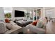 Bright and airy living room featuring a comfortable sectional sofa, large windows, and sliding glass doors at 13208 Leggett Aly, Orlando, FL 32827
