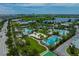 A high-angle aerial view of an elaborate community pool area with many amenities at 13208 Leggett Aly, Orlando, FL 32827