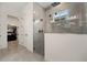Luxurious walk-in shower with glass enclosure, tile surround, and modern fixtures at 13208 Leggett Aly, Orlando, FL 32827