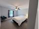 Bedroom with carpet, ceiling fan, window with curtain and sitting area with comfortable chair at 1326 Wildcat Ct, Apopka, FL 32712