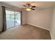 Bedroom with carpet, ceiling fan and sliding glass doors leading to a screened lanai at 1326 Wildcat Ct, Apopka, FL 32712
