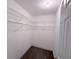 Walk-in closet featuring ample shelving and organization space, with neutral carpeting and white walls at 1326 Wildcat Ct, Apopka, FL 32712