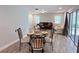 Cozy dining area features stylish furnishings, wood-look flooring, and access to the outdoor area at 1326 Wildcat Ct, Apopka, FL 32712