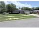 Well-kept single-story home with lush green lawn, a concrete driveway and mature trees at 1326 Wildcat Ct, Apopka, FL 32712