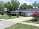 Single-story home with a well-maintained lawn, concrete driveway and nice landscaping at 1326 Wildcat Ct, Apopka, FL 32712